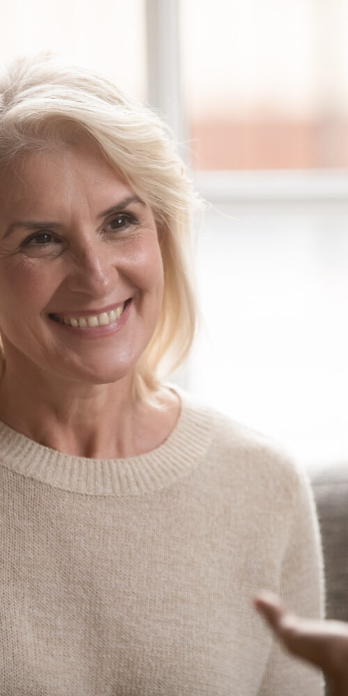 Woman smiling in speech therapy.