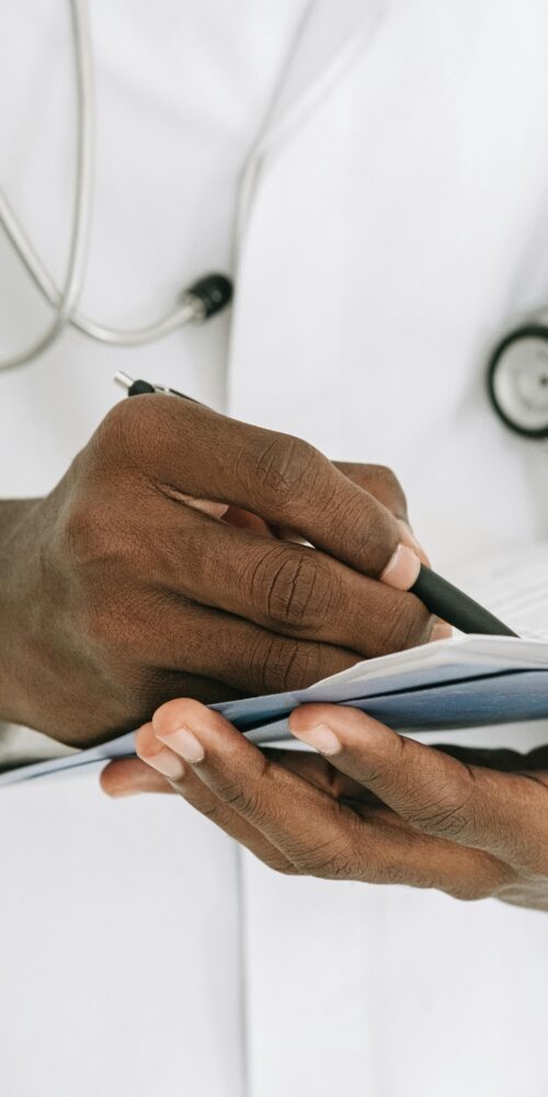 Doctor writing on a notepad.
