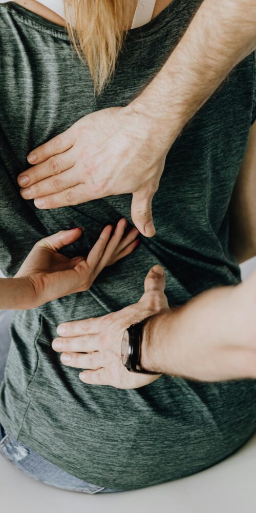 A woman getting treatment from a physical therapist for sciatica.