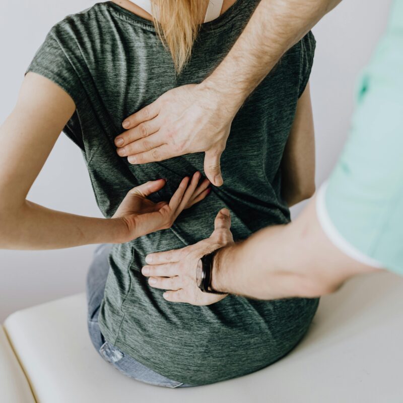 A woman getting treatment from a physical therapist for sciatica.